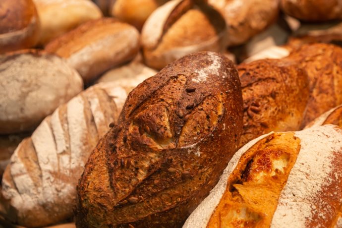 Background of loaves of bread on a bakery showcase.